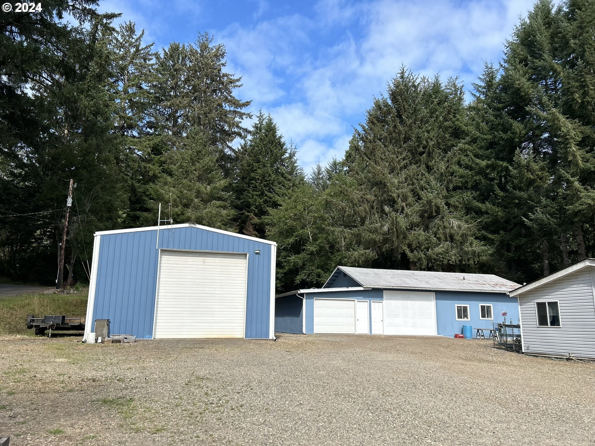 5391 Buckskin Bob Road Florence, OR 97439 - Photo 29 of 42 a front view of a house with a yard and garage