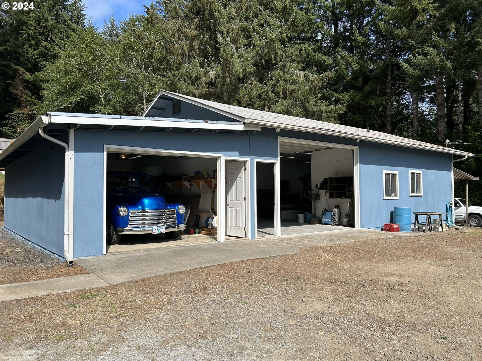 5391 Buckskin Bob Road Florence, OR 97439 - Photo 33 of 42 a view of a house with a patio and a yard