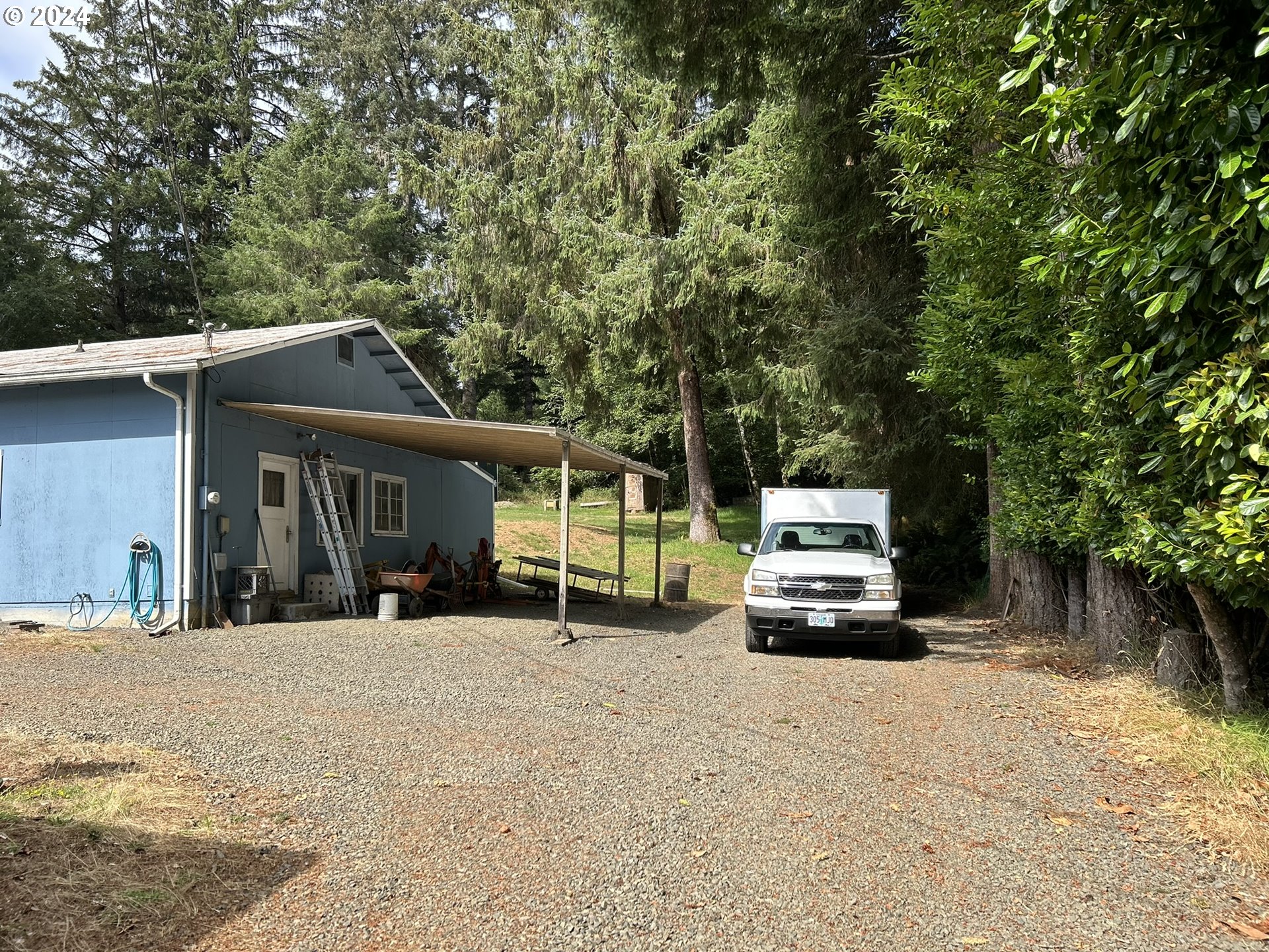 5391 Buckskin Bob Road Florence, OR 97439 - Photo 39 of 42 a view of a street with a car parked in front of it
