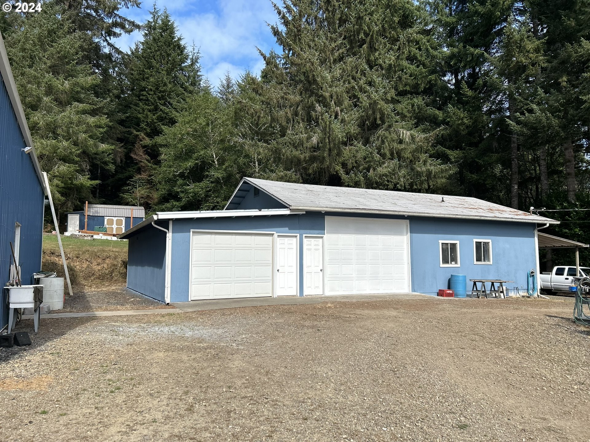 5391 Buckskin Bob Road Florence, OR 97439 - Photo 4 of 42 a front view of a house with a yard and garage