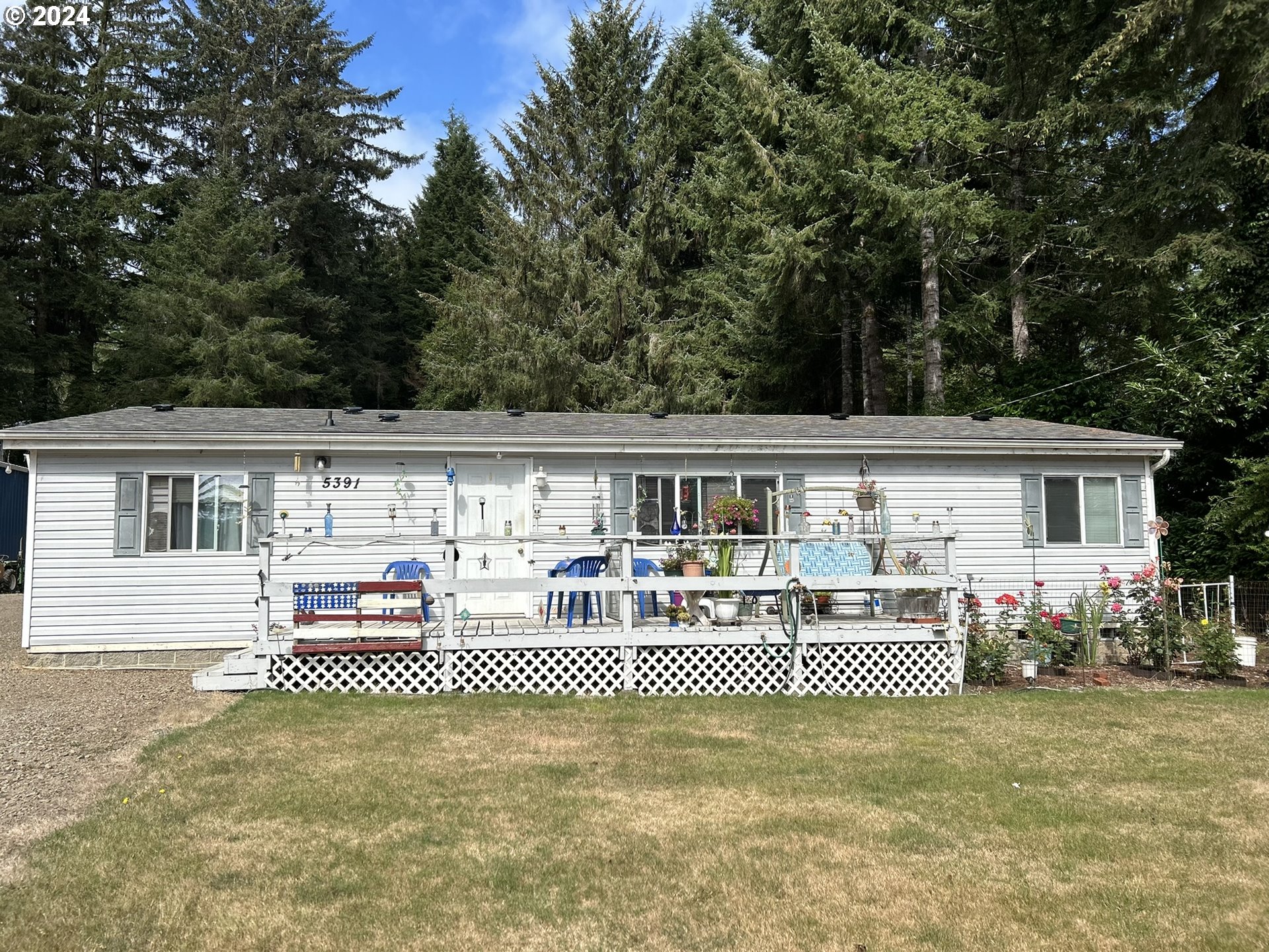 5391 Buckskin Bob Road Florence, OR 97439 - Photo 6 of 42 a front view of a house with a yard