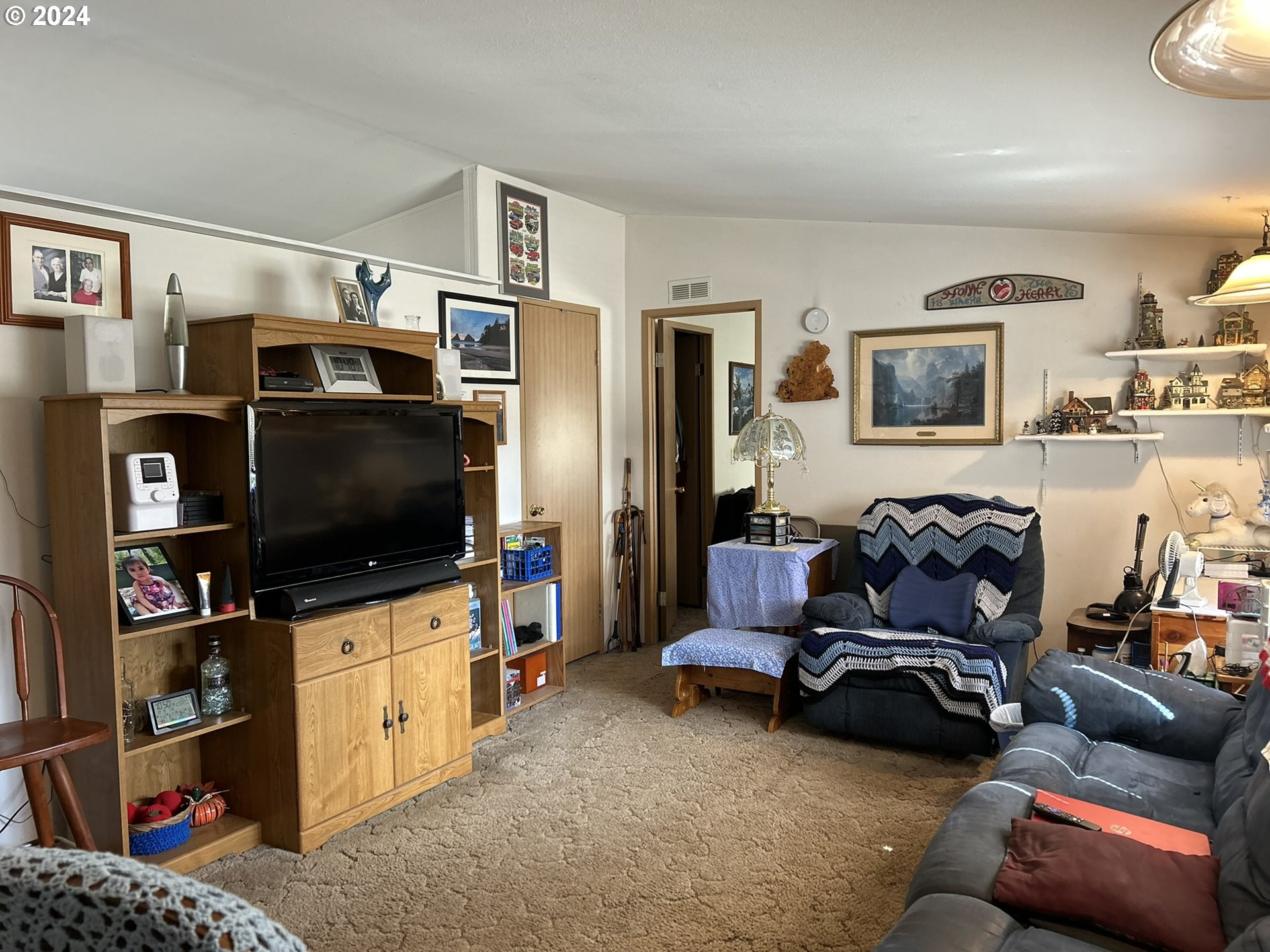 5391 Buckskin Bob Road Florence, OR 97439 - Photo 9 of 42 a living room with furniture and a flat screen tv