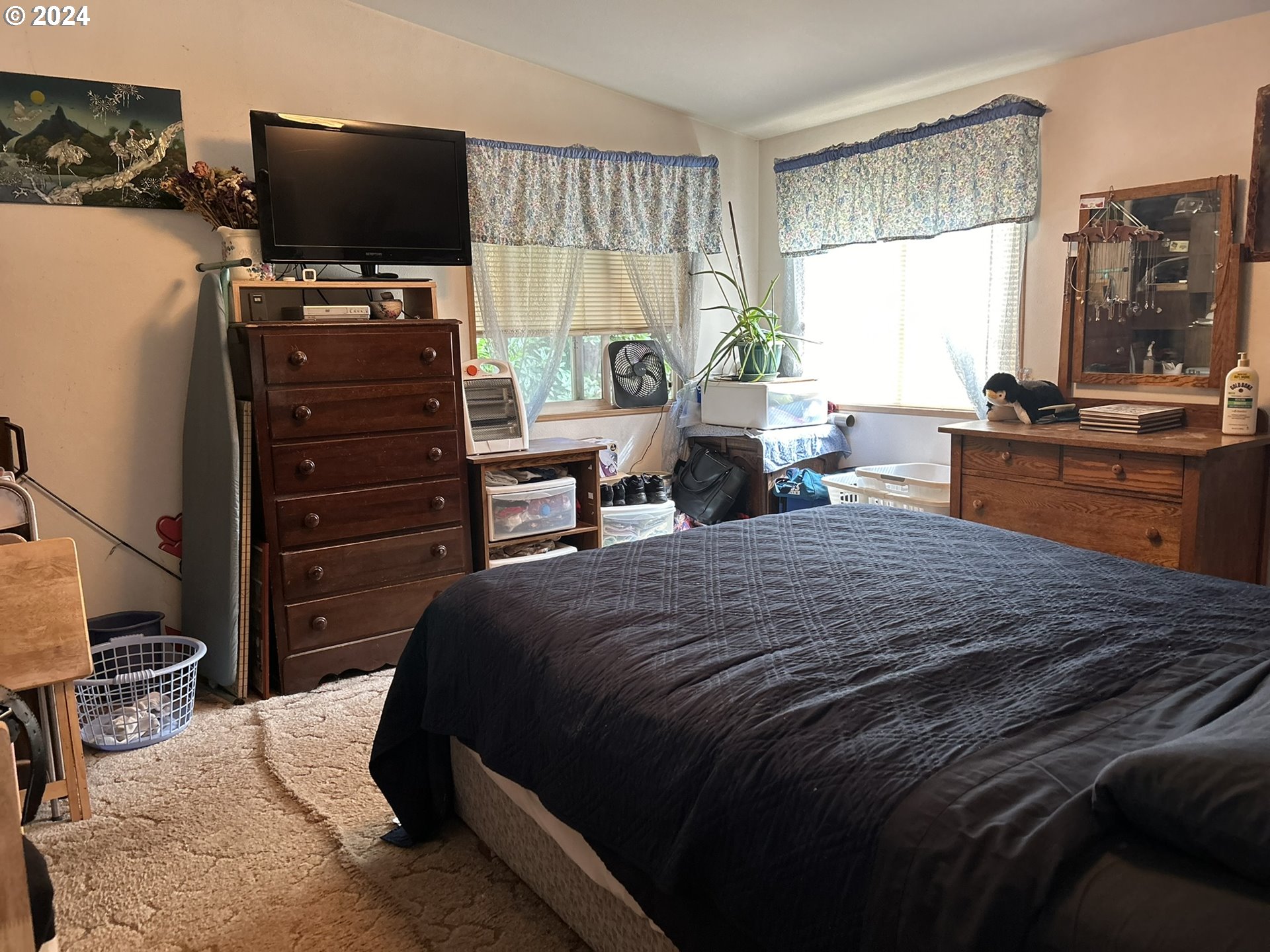 5391 Buckskin Bob Road Florence, OR 97439 - Photo 10 of 42 a bedroom with a bed and wooden floor