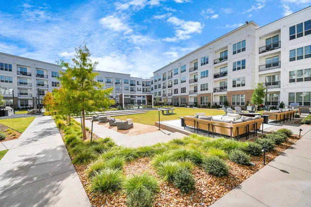 a view of swimming pool with outdoor seating and a patio