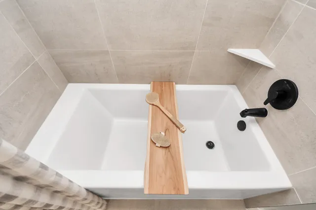 a living room with furniture fireplace and large windows