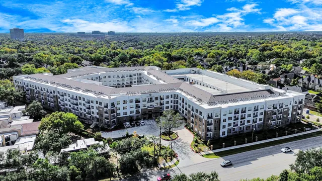a large white kitchen with a sink and dishwasher with wooden floor