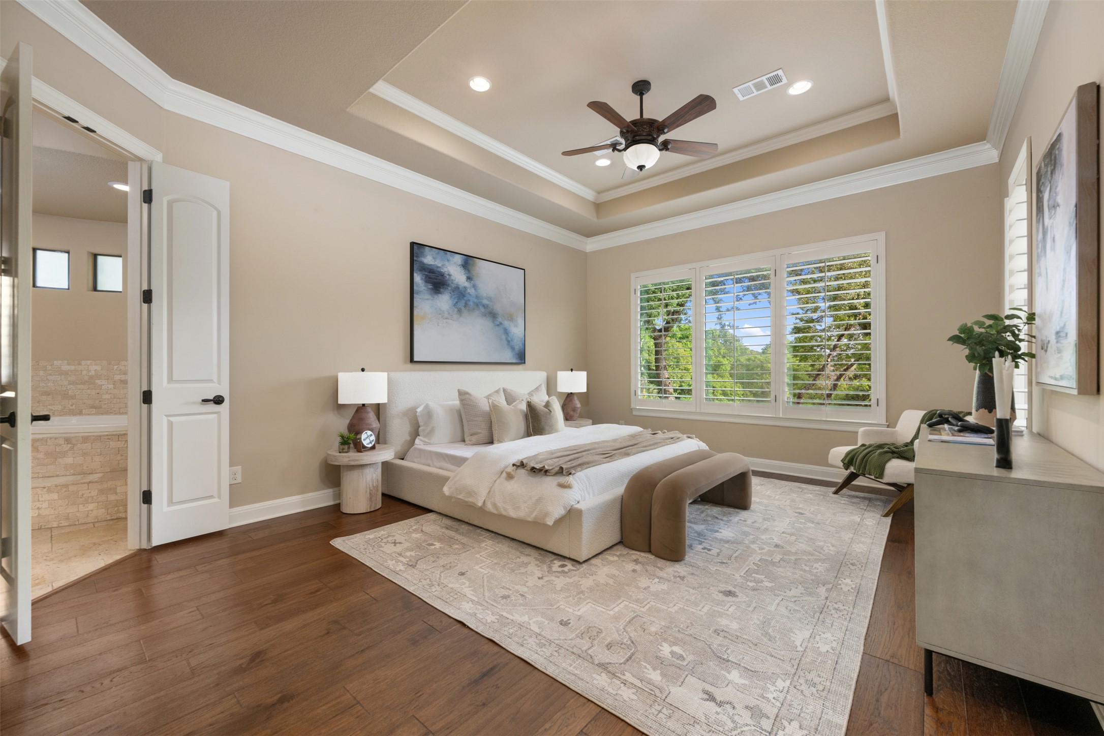 1102 Paw Print Leander, TX 78641 - Photo 18 of 40 This room features hardwood flooring, a tray ceiling with recessed lighting and a ceiling fan, and large windows with privacy shutters