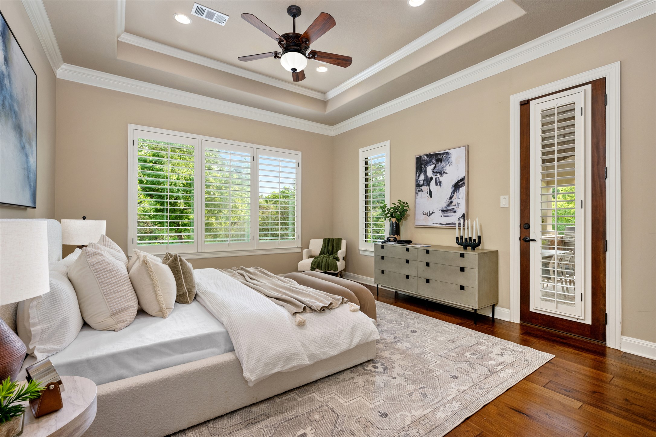 1102 Paw Print Leander, TX 78641 - Photo 19 of 40 The room features rich hardwood flooring, a tray ceiling with recessed lighting, and a ceiling fan