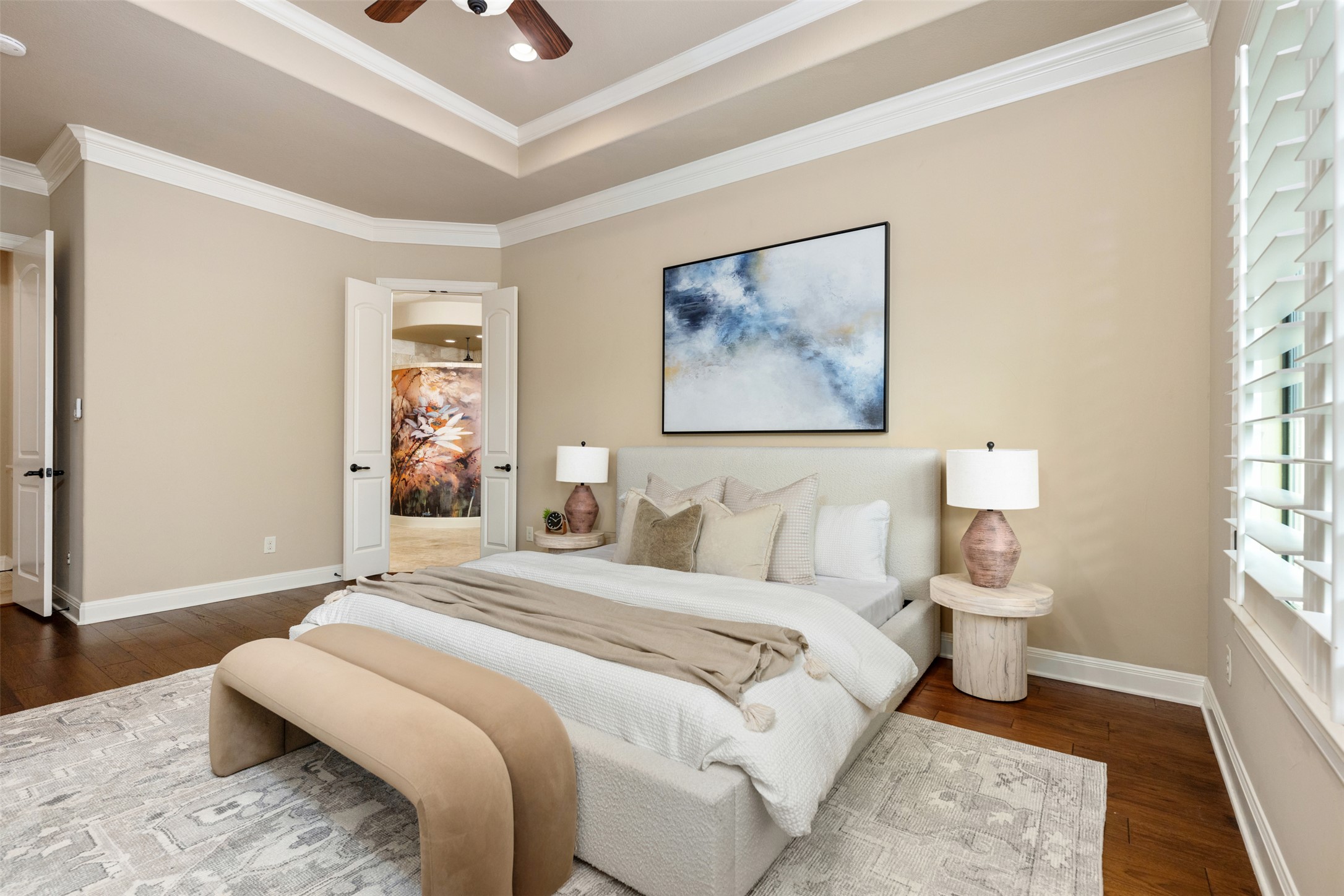 1102 Paw Print Leander, TX 78641 - Photo 20 of 40 The bedroom features hardwood floors, a tray ceiling with a ceiling fan, and crown molding