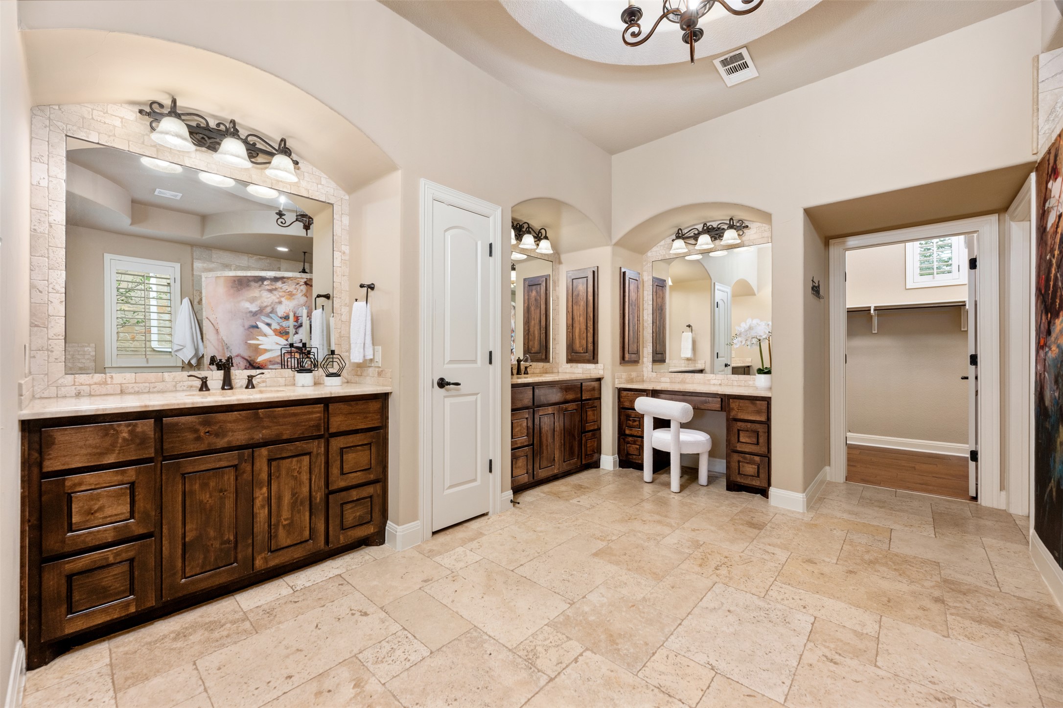 1102 Paw Print Leander, TX 78641 - Photo 21 of 40 The bathroom features a spacious layout with tiled flooring, dark wood vanity cabinets, and a decorative ceiling fixture