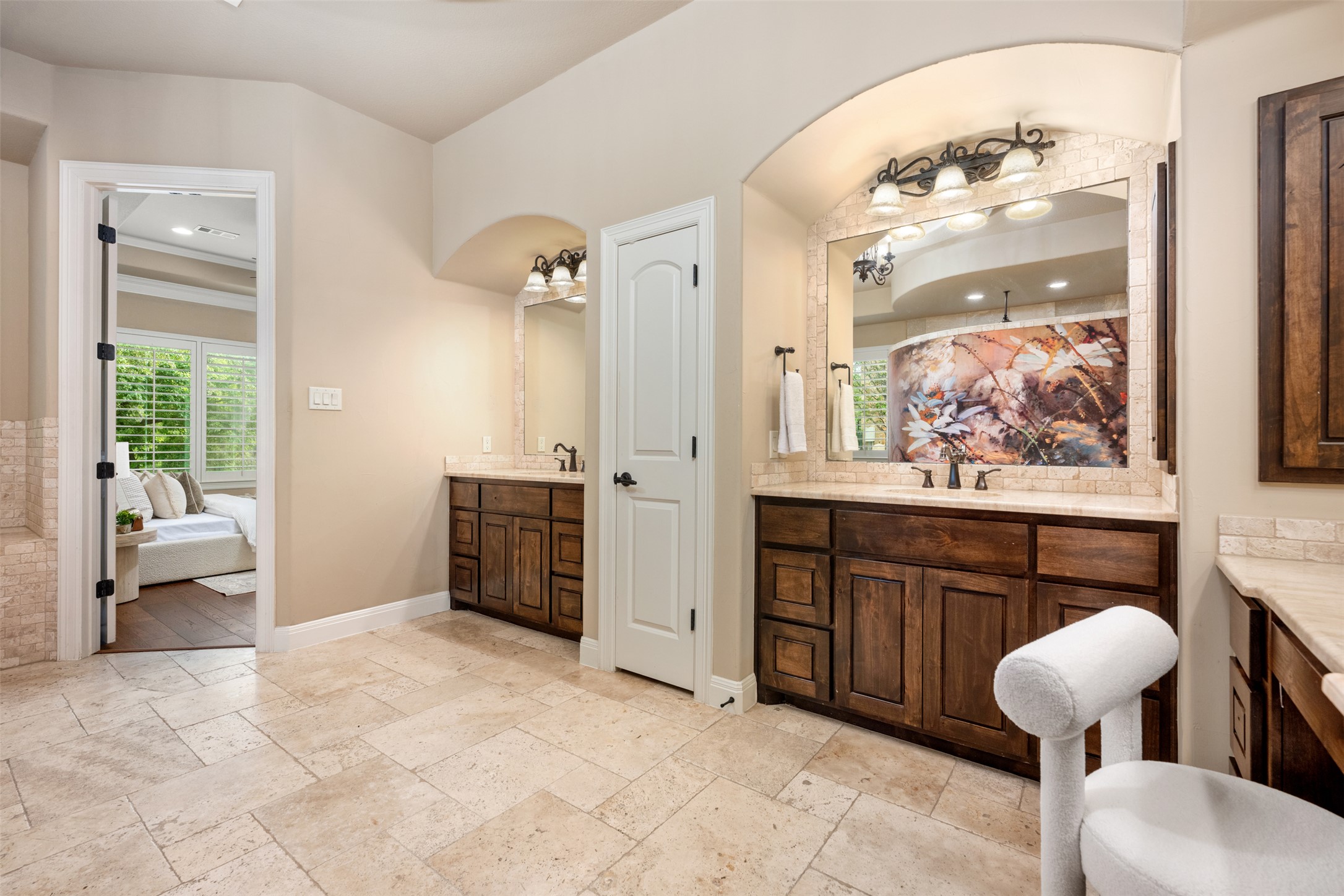 1102 Paw Print Leander, TX 78641 - Photo 22 of 40 The property features a bathroom with light-colored tile flooring and two separate vanities with dark wood cabinetry and light countertops