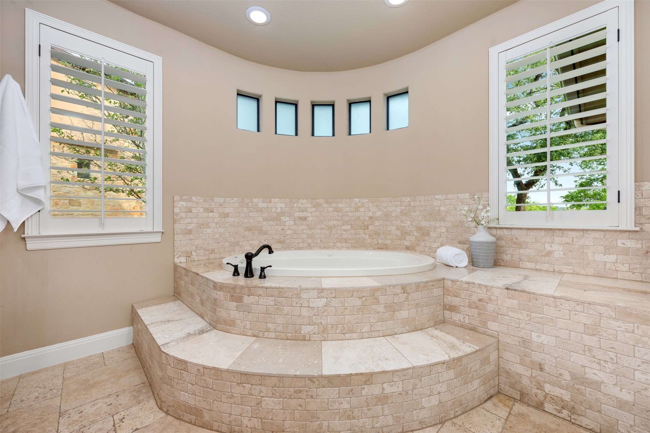 1102 Paw Print Leander, TX 78641 - Photo 23 of 40 The bathroom features a built-in bathtub surrounded by a tiled raised platform with steps