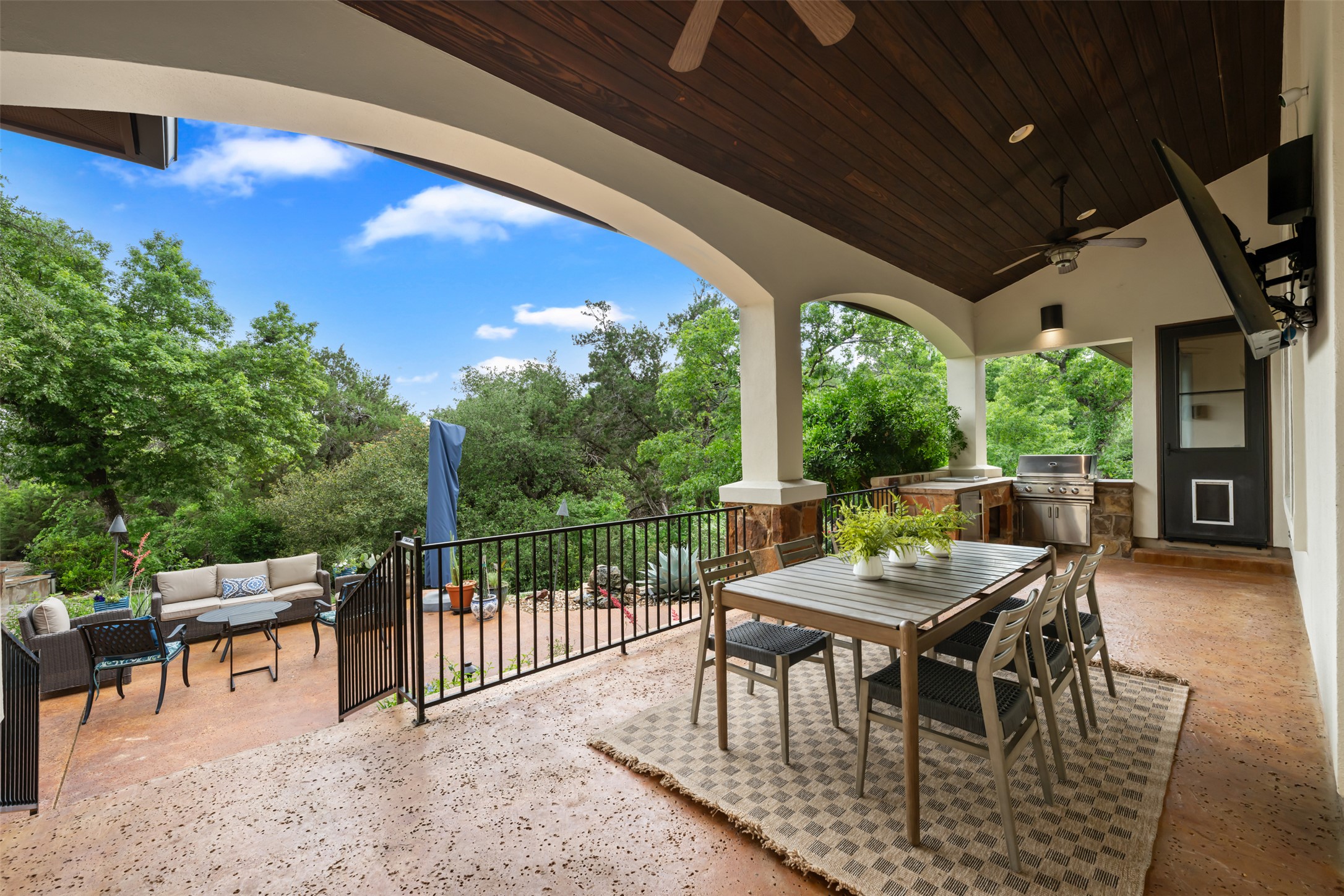 1102 Paw Print Leander, TX 78641 - Photo 27 of 40 Expansive covered patio with a dark wood ceiling, ceiling fans, and an outdoor kitchen area