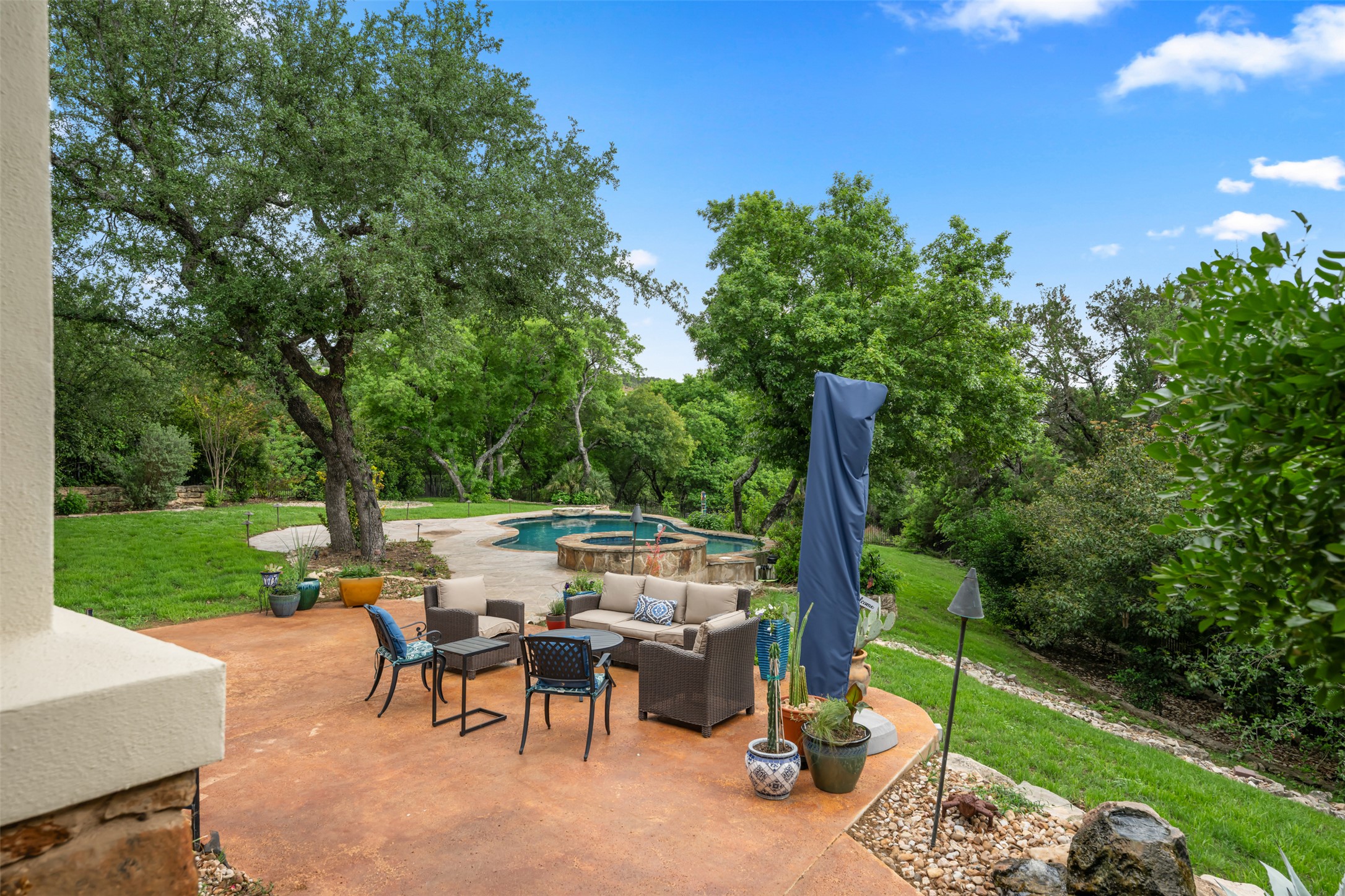 1102 Paw Print Leander, TX 78641 - Photo 29 of 40 The property features a spacious outdoor patio with a concrete surface, a swimming pool, and a spa