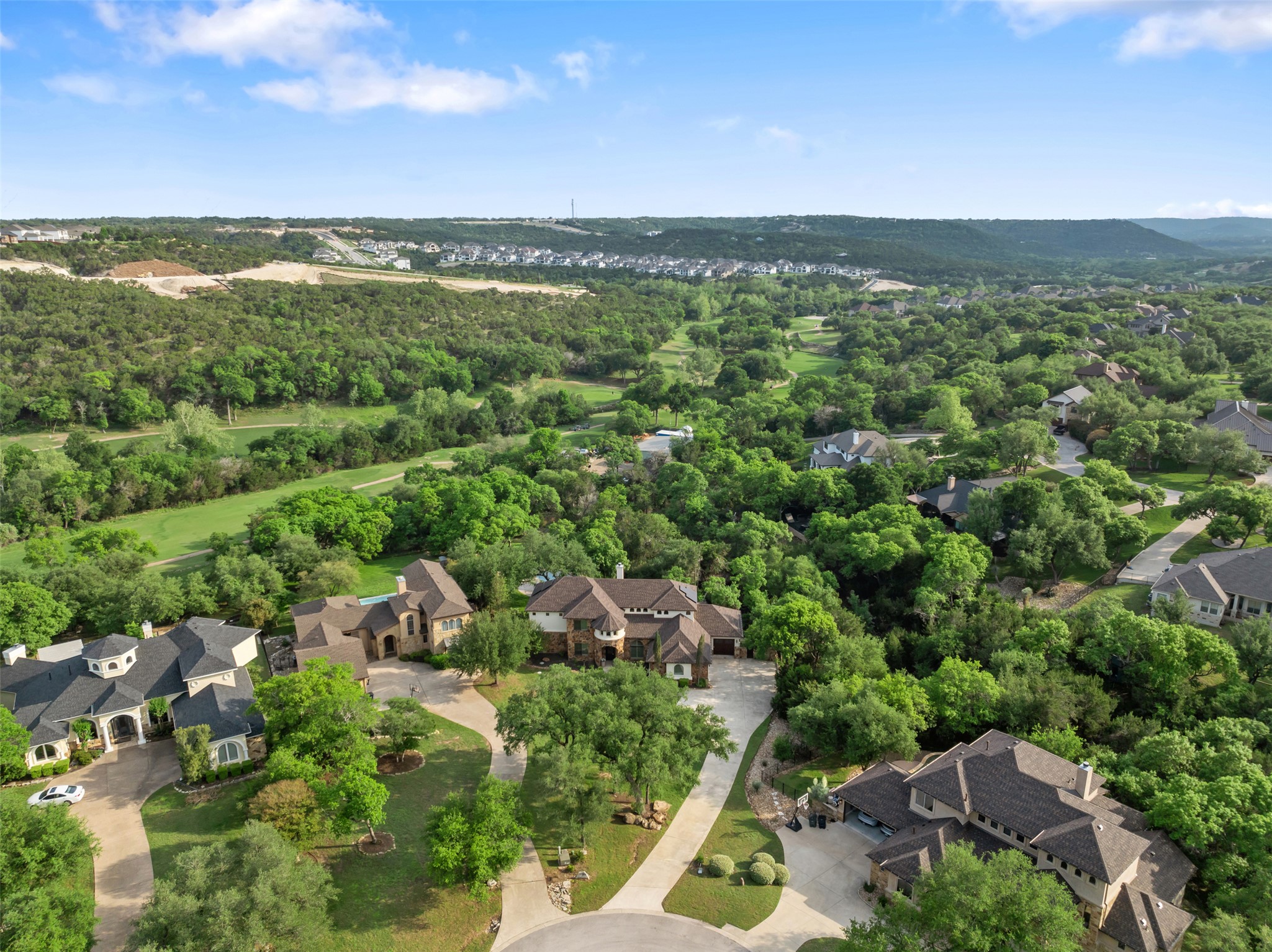 1102 Paw Print Leander, TX 78641 - Photo 34 of 40 An aerial view of the property and its surrounding area, featuring a neighborhood with mature trees and extensive green spaces