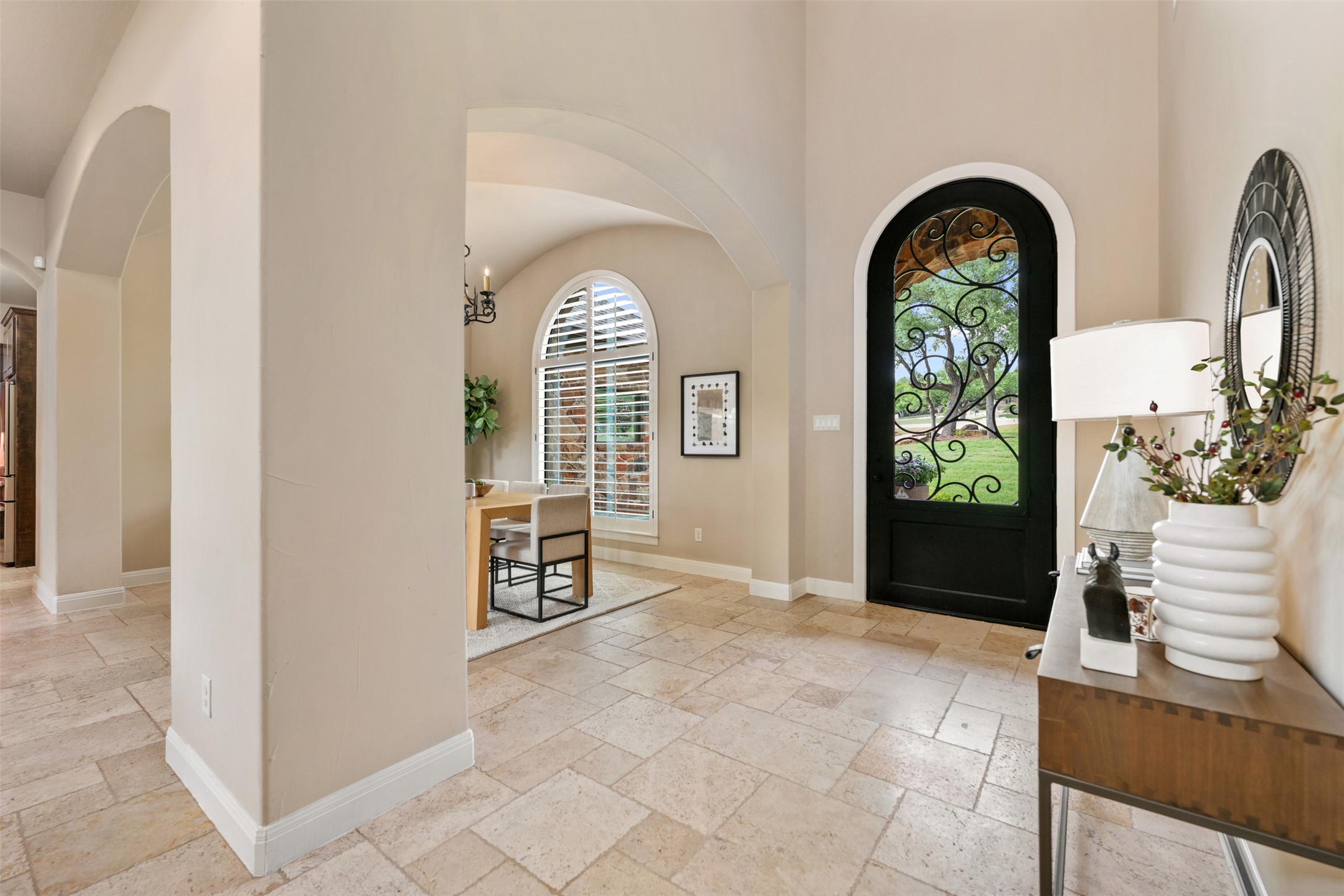 1102 Paw Print Leander, TX 78641 - Photo 5 of 40 The property features an entryway with light-toned tiled flooring and arched doorways leading to other areas
