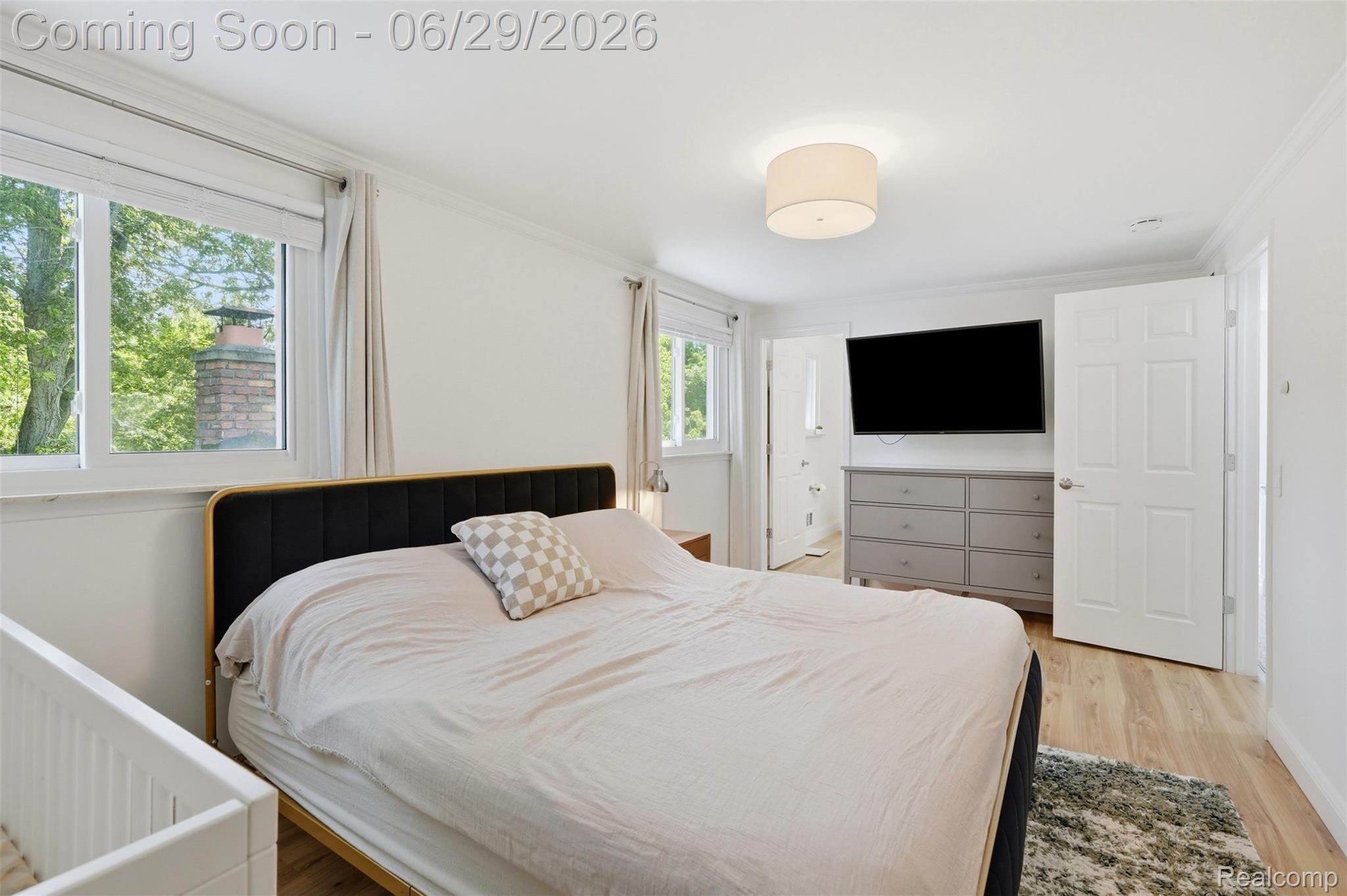 45179 Rudgate Road Canton, MI 48188 - Photo 19 of 48 Bright bedroom featuring light wood-finish flooring, white walls, and crown molding