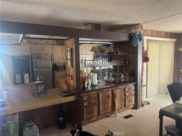 a view of a hallway to a livingroom with furniture