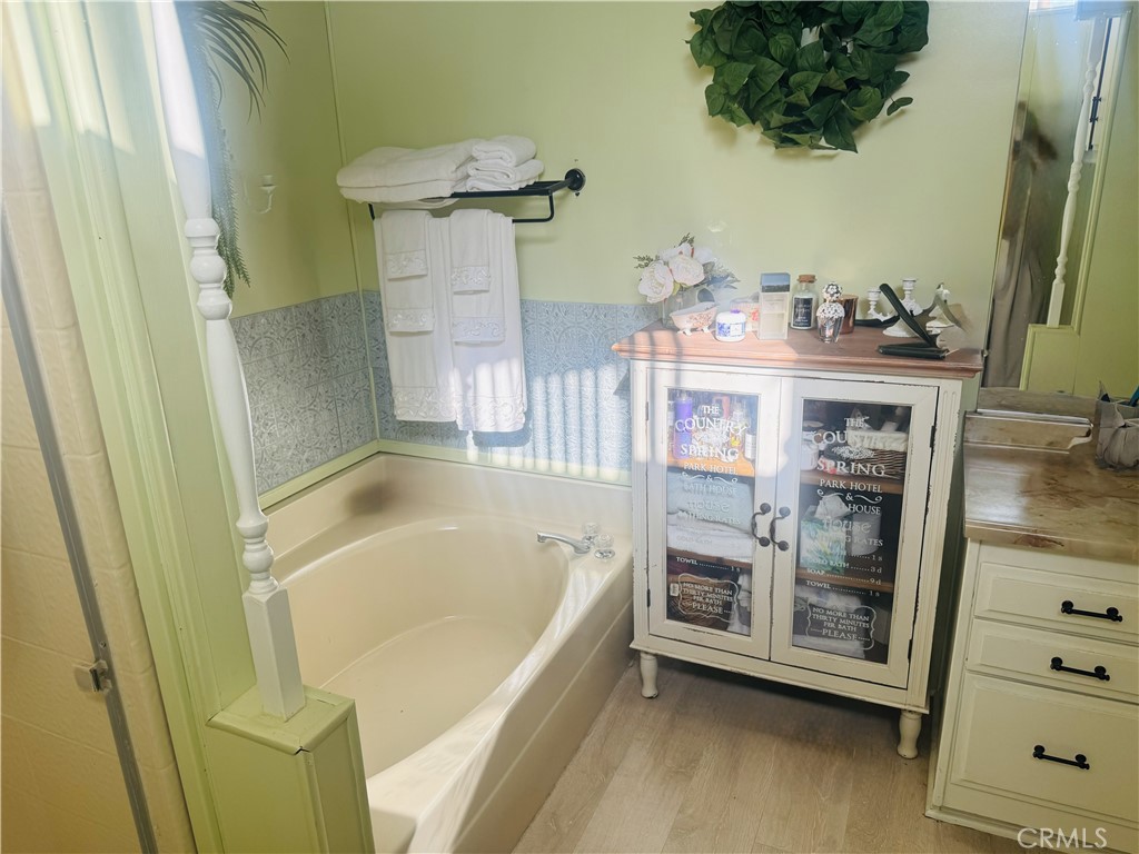 4133 West Wilson Street, Unit 169 Banning, CA 92220 - Photo 18 of 37 a bathroom with a tub and a shower