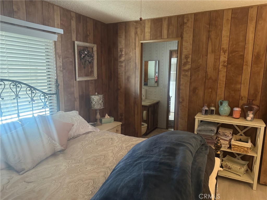 4133 West Wilson Street, Unit 169 Banning, CA 92220 - Photo 20 of 37 a bedroom with a bed and a table