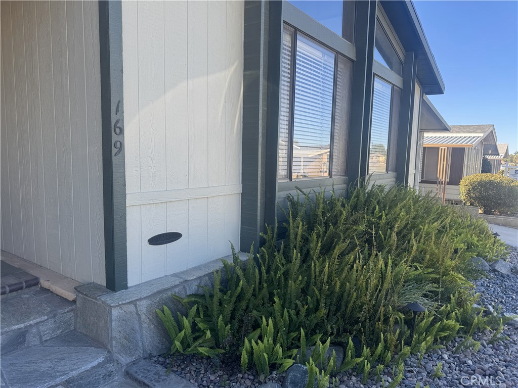 4133 West Wilson Street, Unit 169 Banning, CA 92220 - Photo 35 of 37 a view of a door and chair in front of house