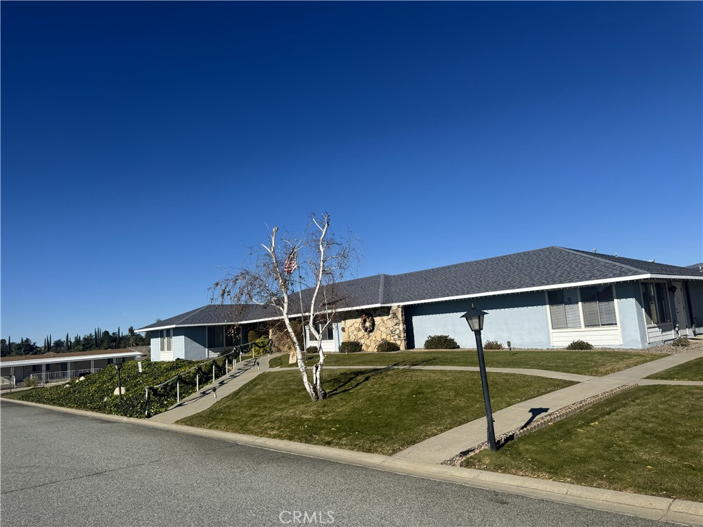 4133 West Wilson Street, Unit 169 Banning, CA 92220 - Photo 36 of 37 a front view of a house with garden