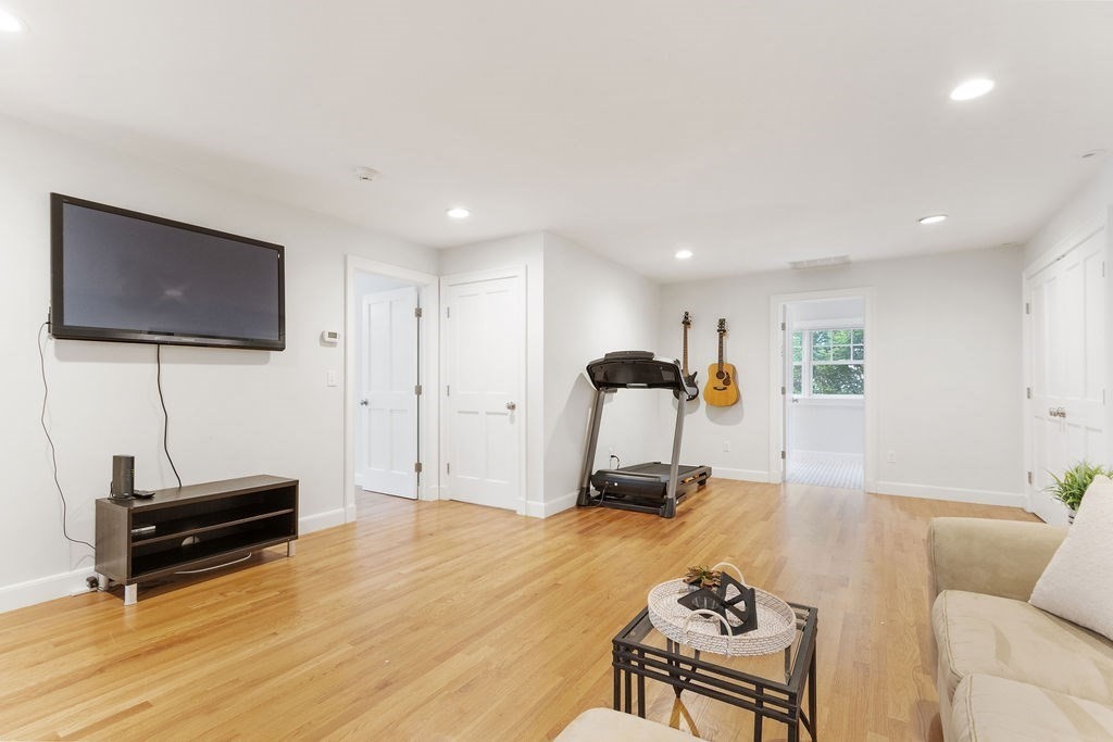 5 Mayflower Road Needham, MA 02492 - Photo 21 of 30 a living room with furniture a flat screen tv and a window