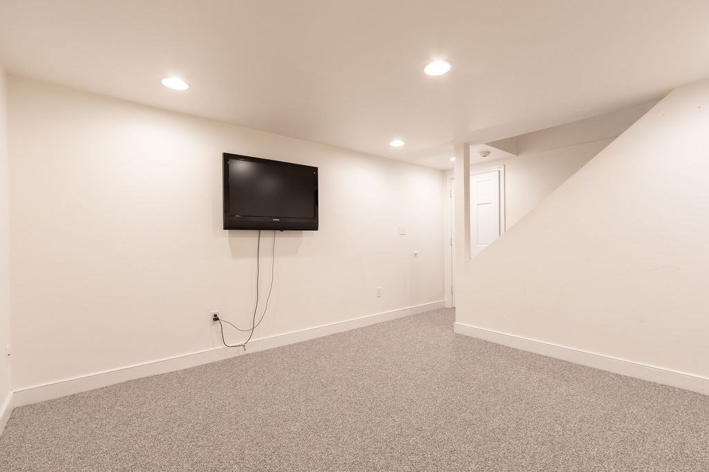 5 Mayflower Road Needham, MA 02492 - Photo 23 of 30 an empty room with a flat screen tv