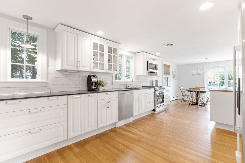 5 Mayflower Road Needham, MA 02492 - Photo 8 of 30 a kitchen with granite countertop white cabinets and white appliances