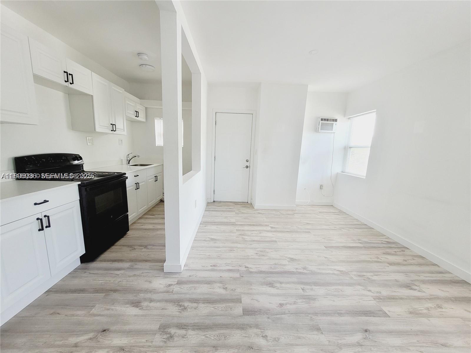 a kitchen with granite countertop a refrigerator and a stove top oven