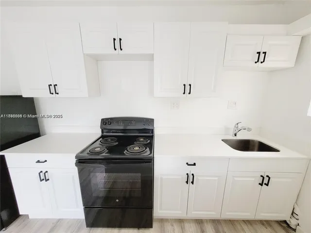 a kitchen with a stove and a cabinets
