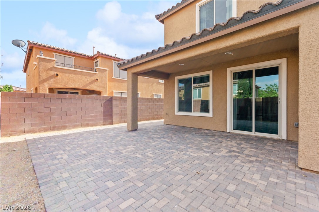 11048 Prairie Grove Road Las Vegas, NV 89179 - Photo 69 of 75 A spacious, paver-lined patio area extends from the home, offering an ideal spot for outdoor gatherings.