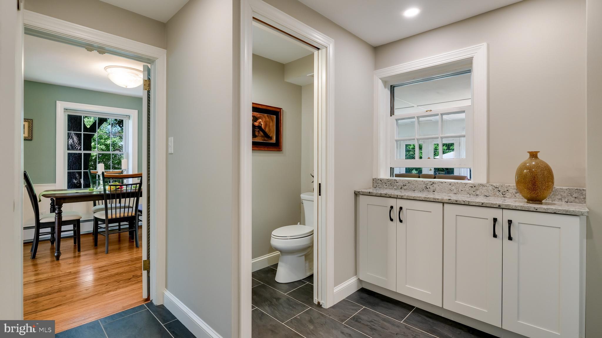 235 North Clinton Street Doylestown, PA 18901 - Photo 28 of 55 a bathroom with a granite countertop sink a toilet and a mirror