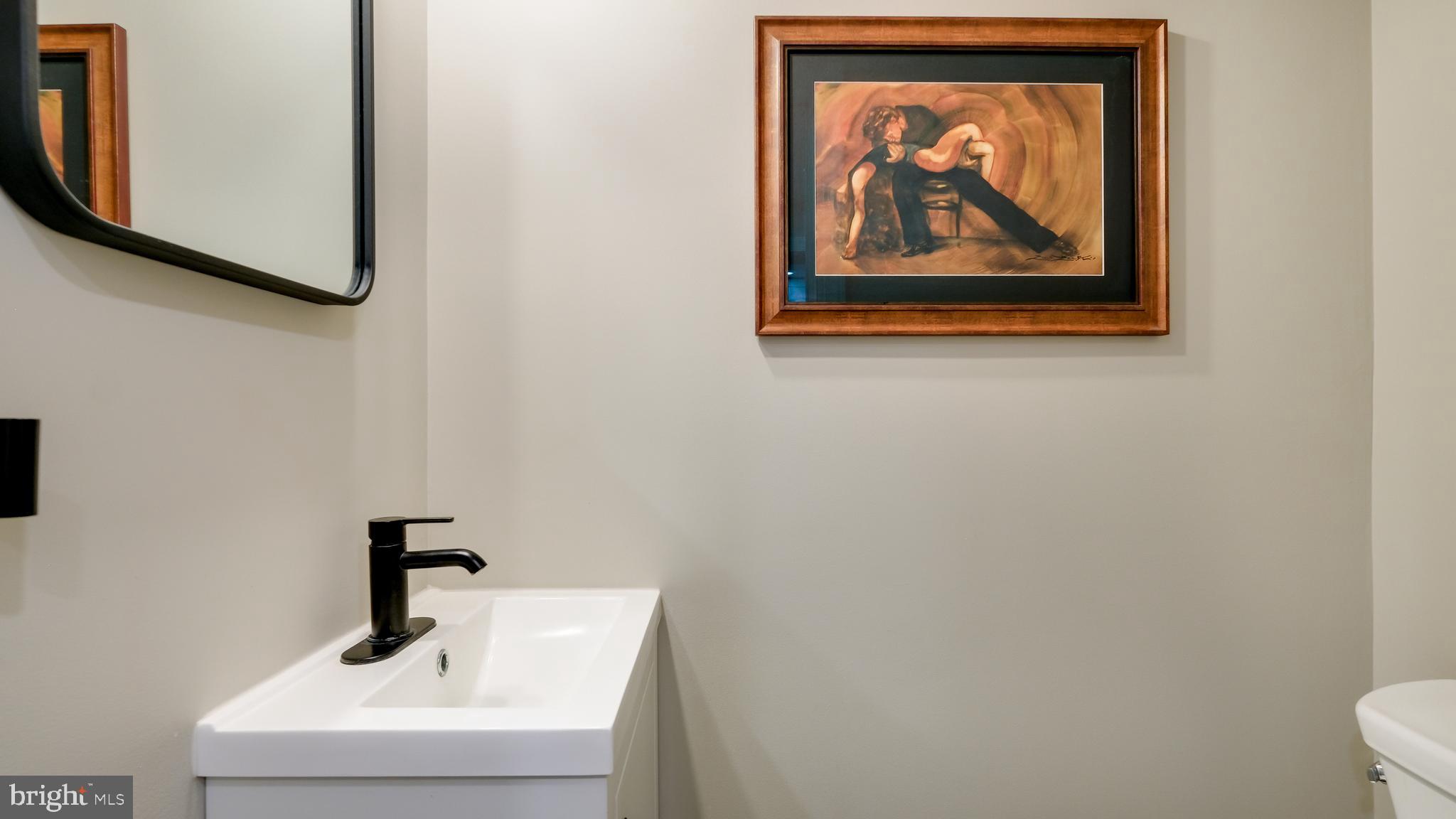235 North Clinton Street Doylestown, PA 18901 - Photo 29 of 55 a bathroom with a sink and a mirror