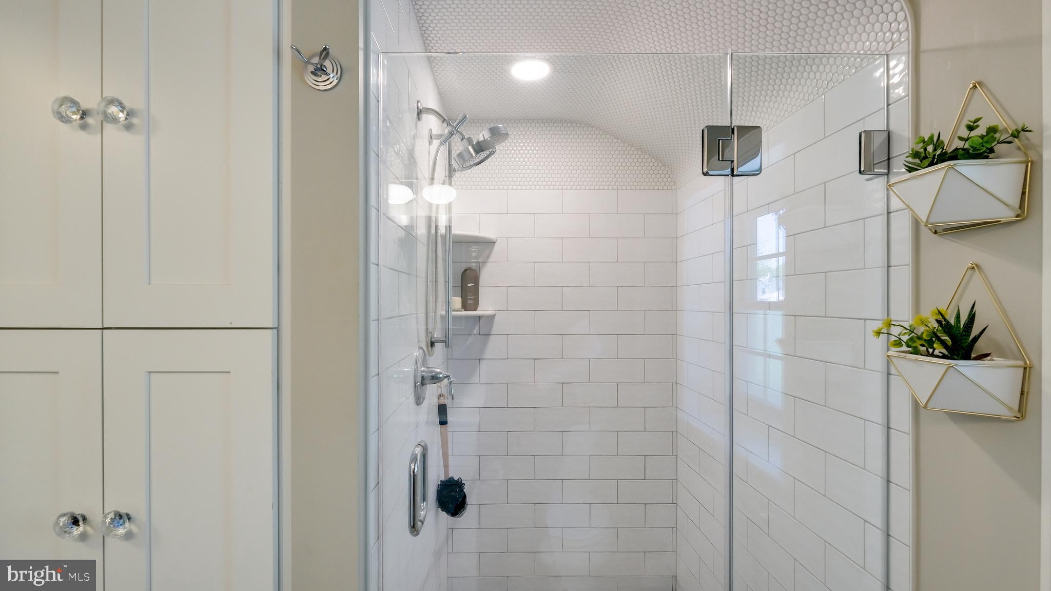 235 North Clinton Street Doylestown, PA 18901 - Photo 34 of 55 a bathroom with a glass shower door and a shower