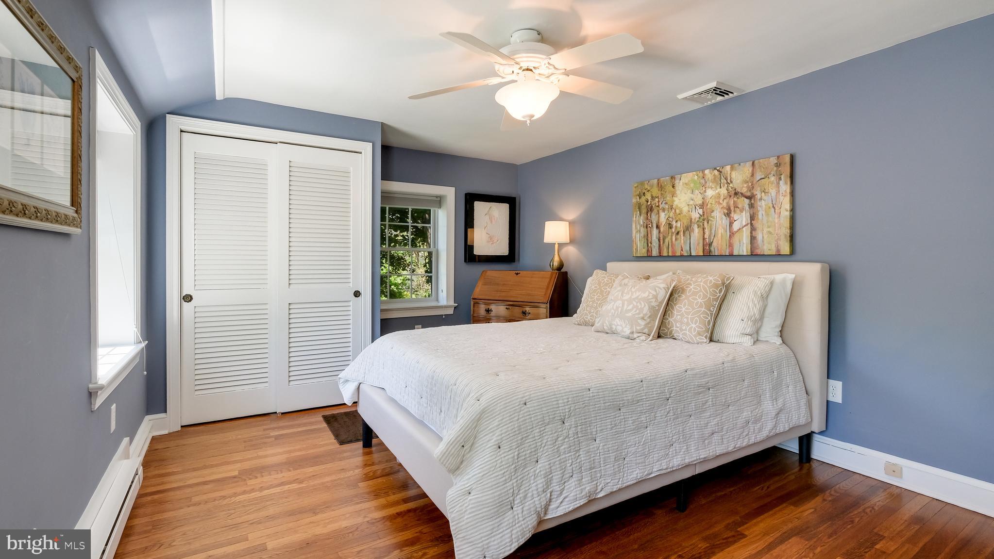 235 North Clinton Street Doylestown, PA 18901 - Photo 36 of 55 a bedroom with a large bed and a chandelier