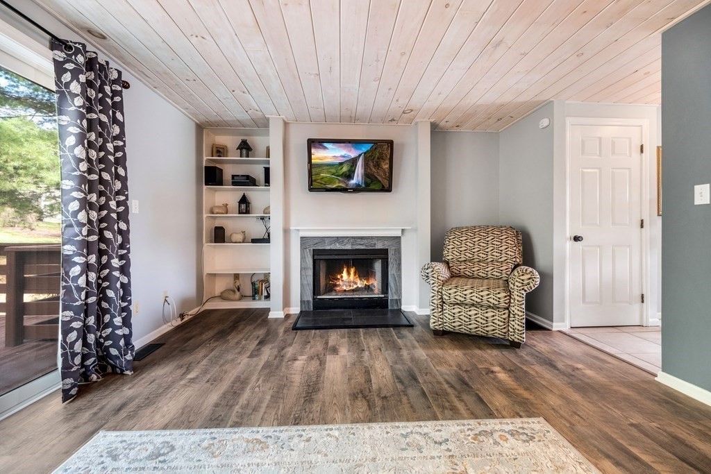 55 Stone Ridge Road, Unit 55 Franklin, MA 02038 - Photo 12 of 27 a living room with furniture and a fireplace
