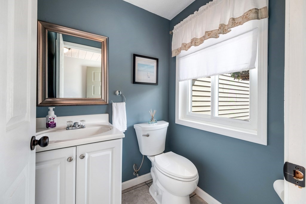 55 Stone Ridge Road, Unit 55 Franklin, MA 02038 - Photo 13 of 27 a bathroom with a toilet sink and mirror