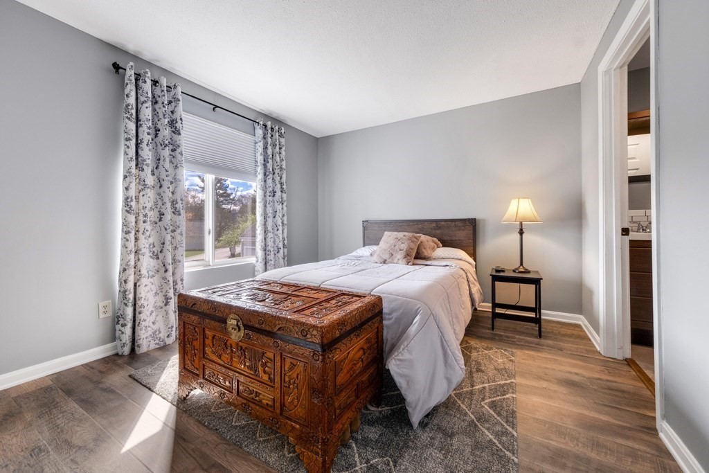 55 Stone Ridge Road, Unit 55 Franklin, MA 02038 - Photo 15 of 27 a bedroom with a bed and a table in it