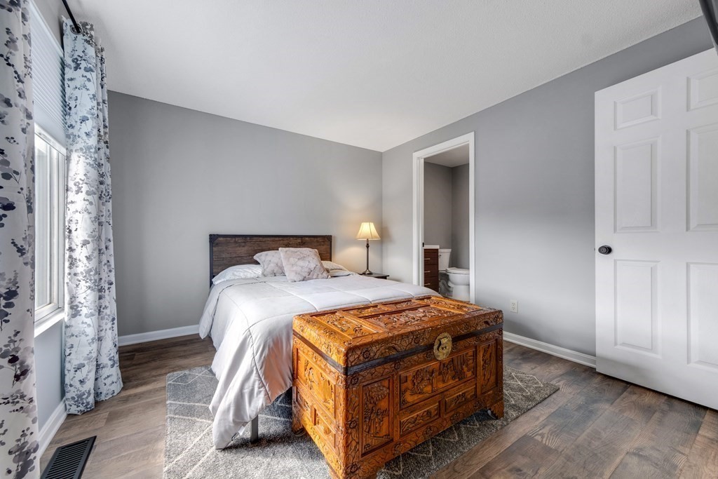 55 Stone Ridge Road, Unit 55 Franklin, MA 02038 - Photo 16 of 27 a bedroom with a bed and a table