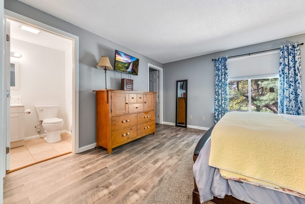 55 Stone Ridge Road, Unit 55 Franklin, MA 02038 - Photo 20 of 27 a bed room with a bed and dresser