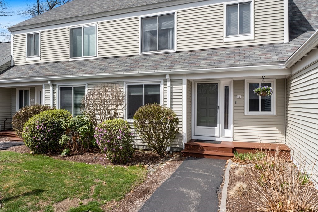 55 Stone Ridge Road, Unit 55 Franklin, MA 02038 - Photo 2 of 27 a front view of a house with garden
