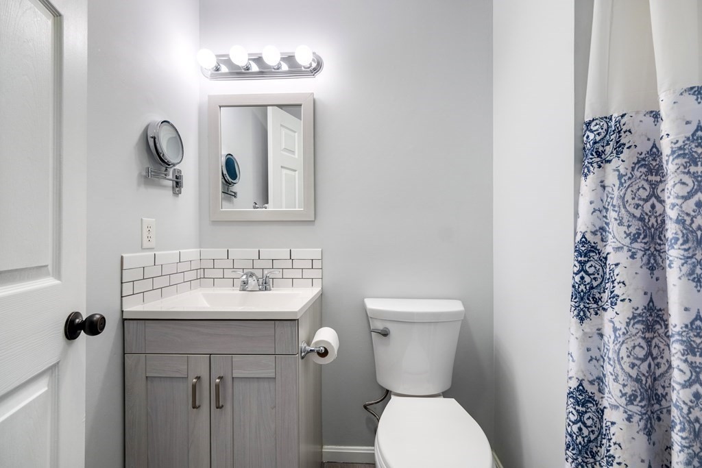 55 Stone Ridge Road, Unit 55 Franklin, MA 02038 - Photo 21 of 27 a bathroom with a toilet sink and mirror