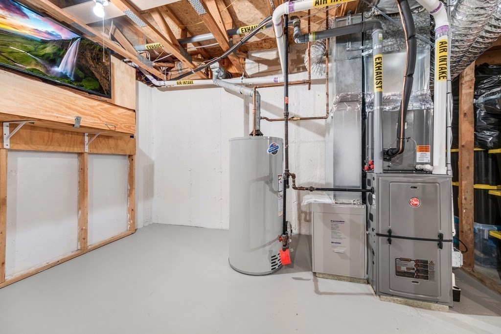 55 Stone Ridge Road, Unit 55 Franklin, MA 02038 - Photo 23 of 27 a view of storage and utility room with washer and dryer