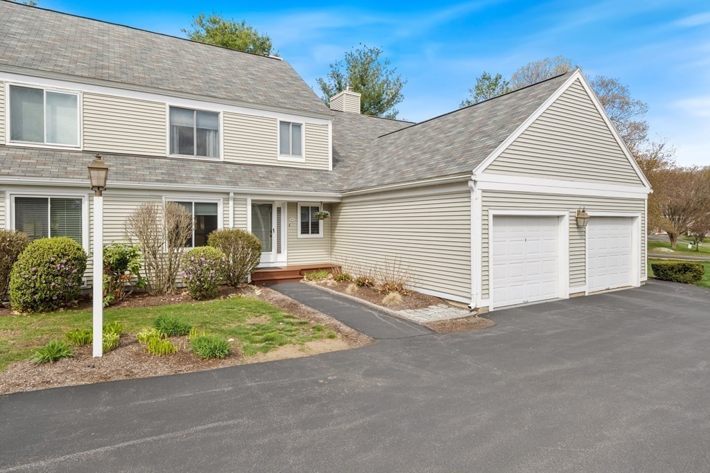 55 Stone Ridge Road, Unit 55 Franklin, MA 02038 - Photo 25 of 27 a view of a house with a yard and garage