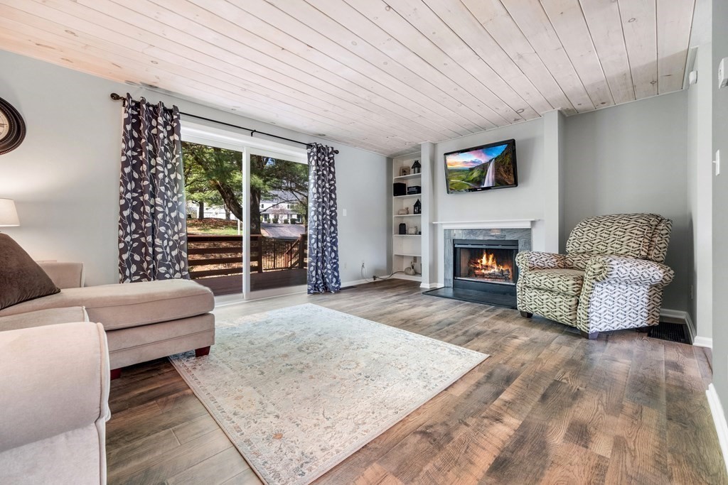 55 Stone Ridge Road, Unit 55 Franklin, MA 02038 - Photo 8 of 27 a living room with furniture and a fireplace