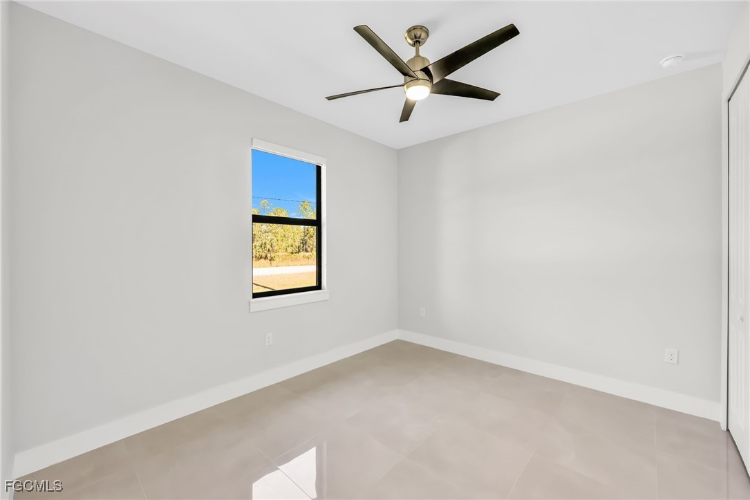 8771-8773 Buckingham Road Lehigh Acres, FL 33971 - Photo 13 of 34 an empty room with a window and a ceiling fan