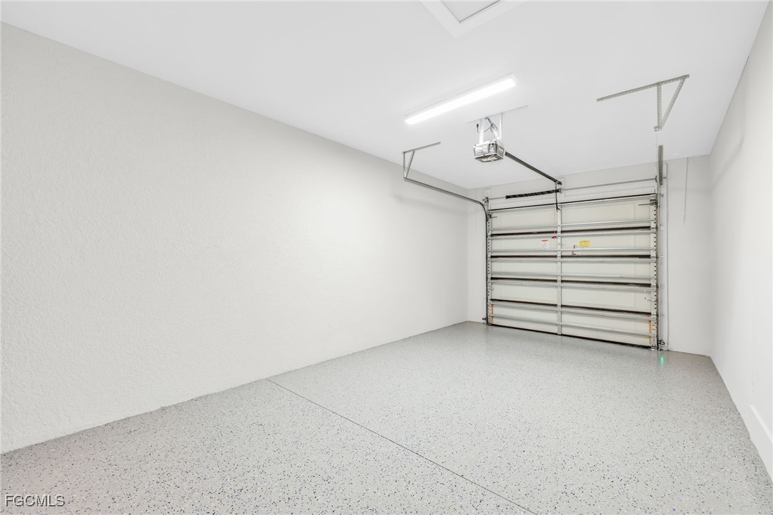 8771-8773 Buckingham Road Lehigh Acres, FL 33971 - Photo 18 of 34 a view of a room with stairs and a ceiling fan