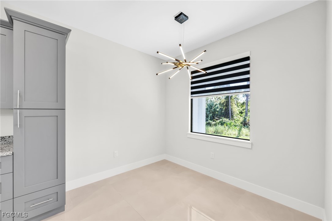 8771-8773 Buckingham Road Lehigh Acres, FL 33971 - Photo 22 of 34 an empty room with windows and ceiling fan