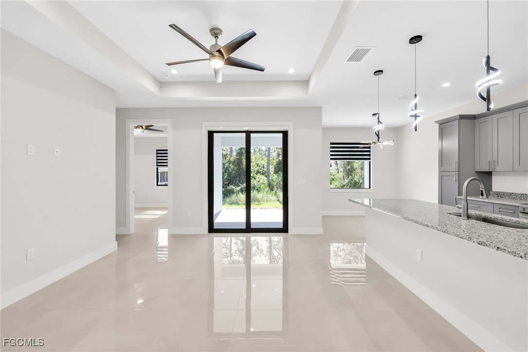 8771-8773 Buckingham Road Lehigh Acres, FL 33971 - Photo 24 of 34 a large kitchen with granite countertop a large window and a sink
